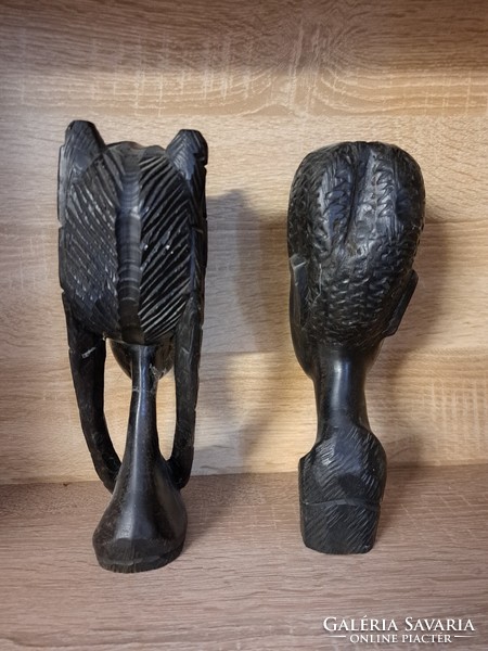 Black, ebony colored, polished female and male native head sculptures