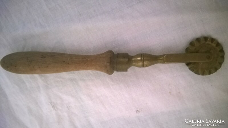 Old copper wood cutter with wooden handle - peaceful, solid piece.