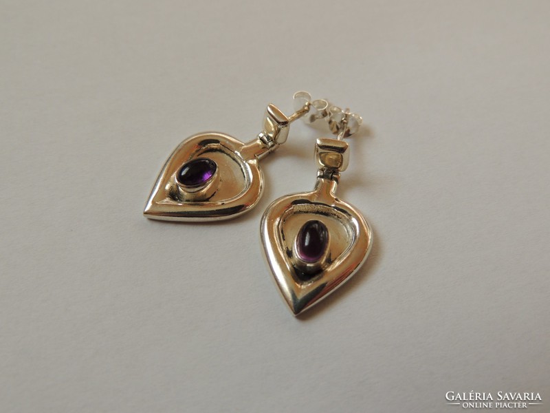 Unique designed silver earrings decorated with amethyst stone