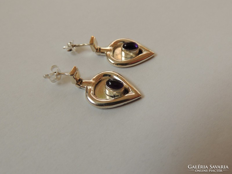 Unique designed silver earrings decorated with amethyst stone