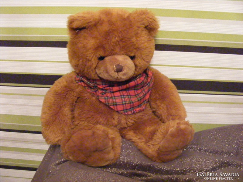 Big teddy bear with a checkered scarf