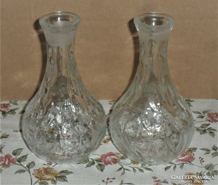 2 oil/vinegar bottles on an oval tupperware tray.