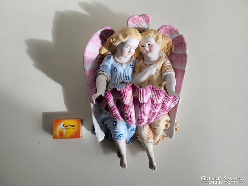 Old biscuit porcelain angels holding a large wall holy water container