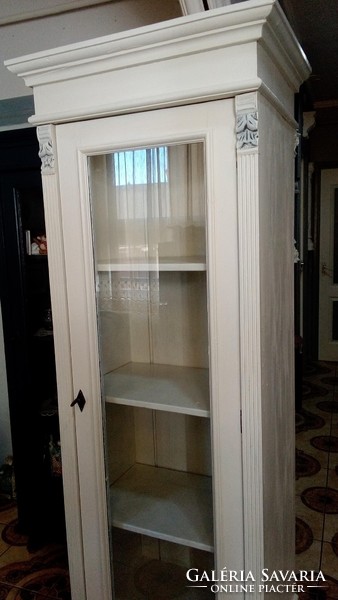 A narrow storage cabinet with bookshelves in German pewter