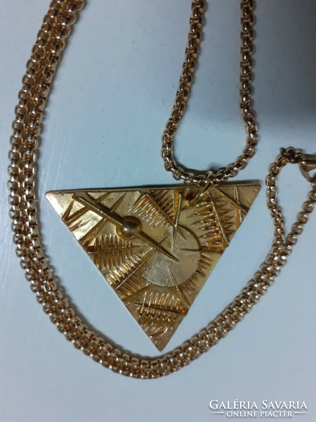 Marked applied arts gilt relief bronze triangle pendant on a gilt thick long chain
