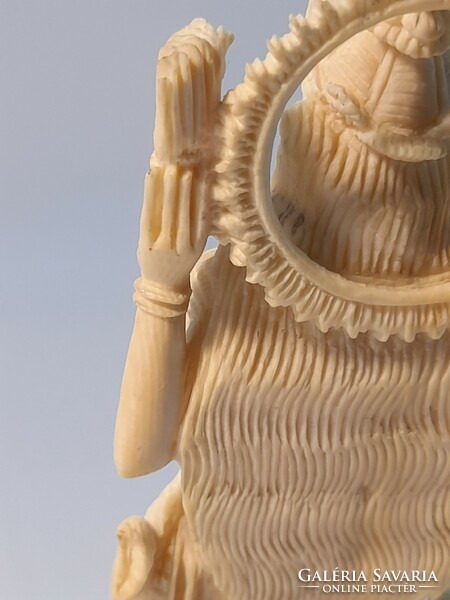 Far Eastern bone statue on a wooden pedestal