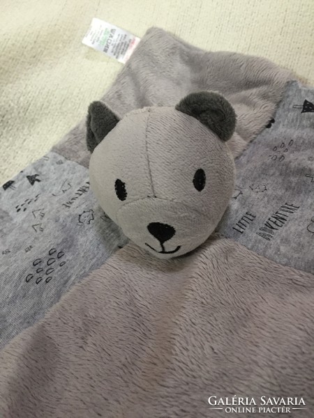 A light gray teddy bear or a doggy cuddly toy