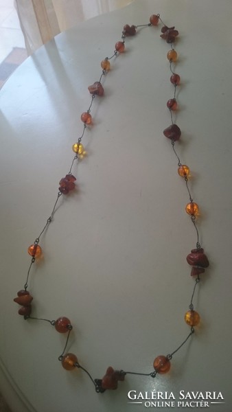 Silver necklace decorated with amber
