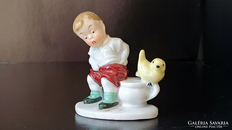 Old German porcelain figure. Little boy with a bird. Mini nip. 5.5 cm.