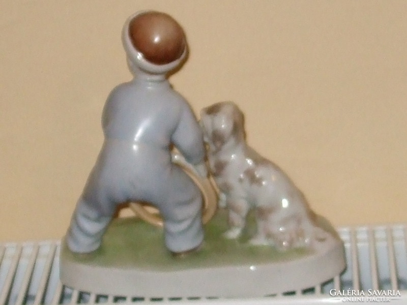 Zsolnay is a boy playing with a dog. Seller!