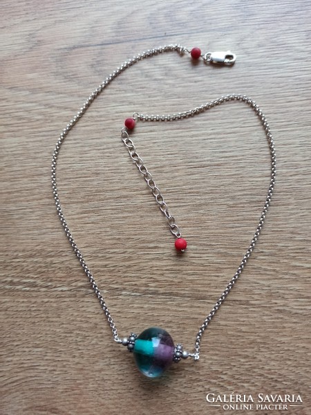 Silver necklace decorated with colored glass.
