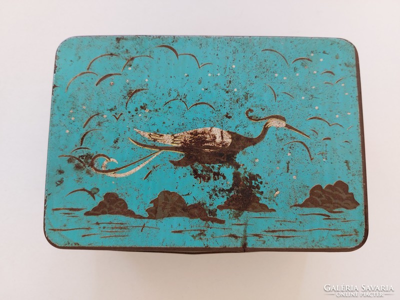 Old metal box with bird pattern
