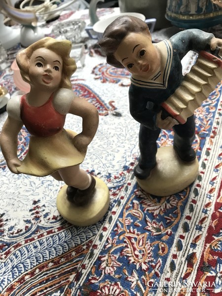 Pair of ceramic figurines dancing girl and boy playing the accordion
