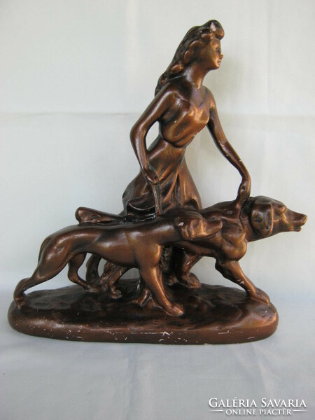 Statue of a woman walking a dog