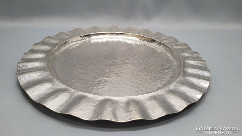 Antique silver serving tray with a hand-hammered pattern
