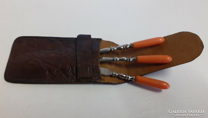 Antique elegant small manicure set with red coral stone handles in a leather case