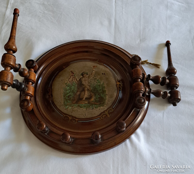 It is decorated with an antique carved hanger, hand-painted picture