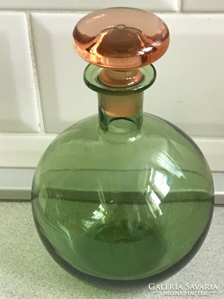 Handcrafted liqueur glass with an olive green base and a peach-colored polished stopper