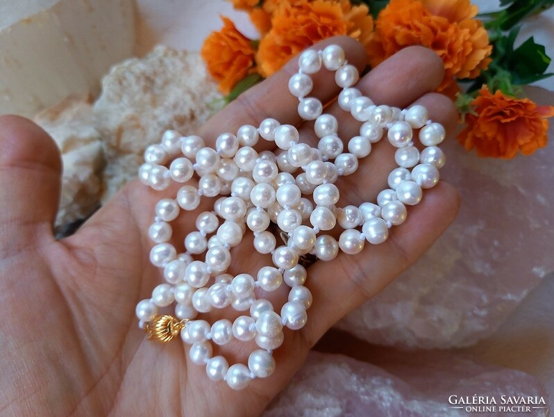 Real room. Long white freshwater pearl necklace made of selected beads, with decorative clasp