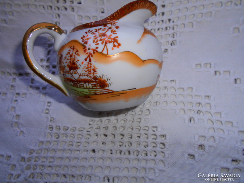 Antique hand-painted porcelain cream jug with a traditional Japanese pattern