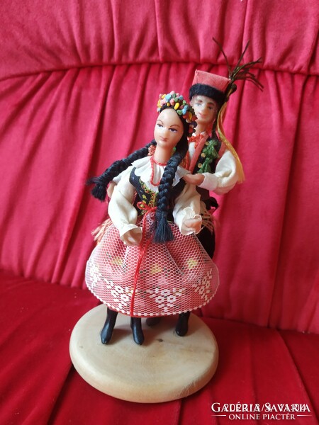 Boys and girls dressed in Polish folk costumes, on wooden legs for sale! Decoration