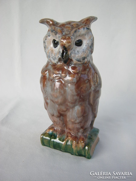 A wise owl sitting on a signed ceramic book