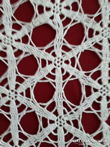 Crocheted hexagonal lace tablecloth with a geometric pattern