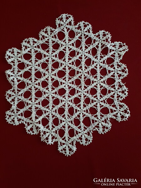 Crocheted hexagonal lace tablecloth with a geometric pattern
