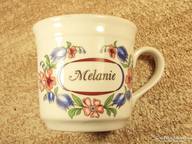 Porcelain mug with the inscription melanie with a flower pattern
