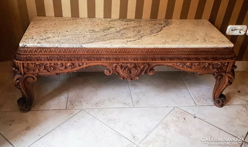 A beautiful console table with a carved marble top