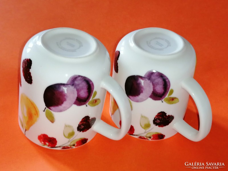 A pair of tasteful mugs with a fruit pattern