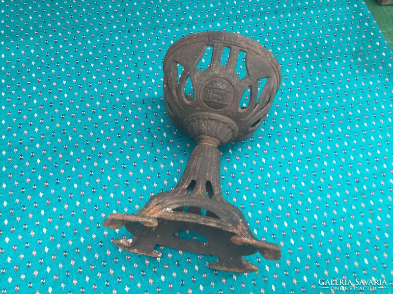 An iron holder in the shape of a chalice, perhaps a church church or peteoleum lamp