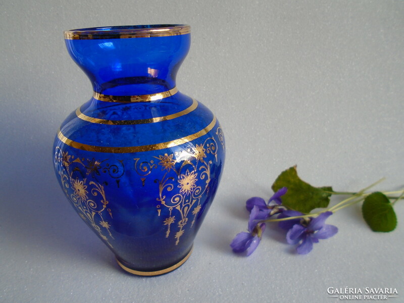 Old, handmade broken violet vase.