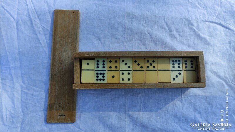 Old plastic dominoes in a wooden box