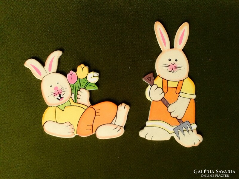 Two cheerful colorful painted wooden bunny rabbit figures, Easter spring garden work tulip flower decoration