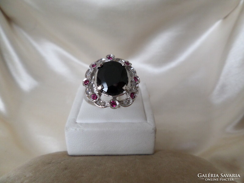 White gold ring with dark blue sapphire, brilles and synthetic ruby
