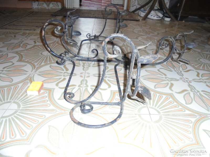 Old wrought iron wall planter for four pots of flowers