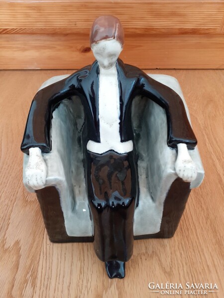 A man sitting in an armchair wearing a tailcoat. Zsolnay art deco sculpture, 1910s