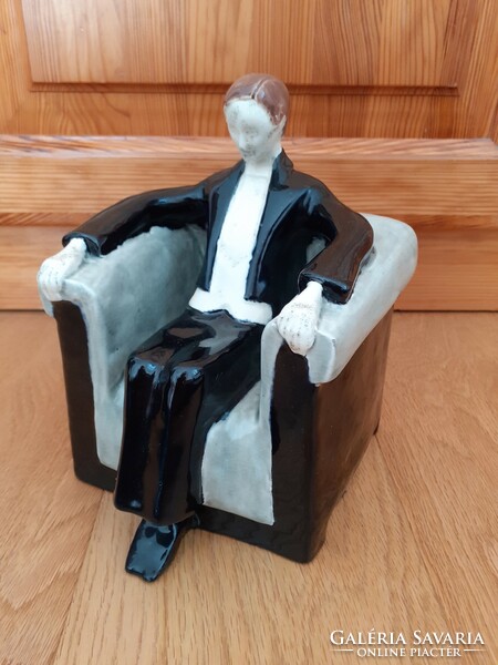A man sitting in an armchair wearing a tailcoat. Zsolnay art deco sculpture, 1910s