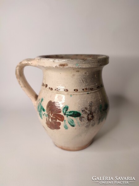 Old small painted folk earthenware pot with flowers