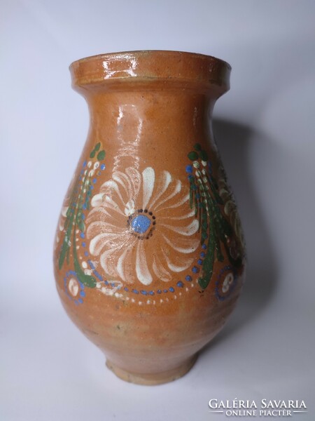 Old painted folk earthen pot with flowers