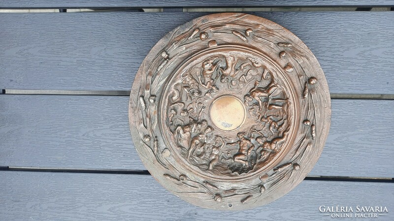 Old bronzed cast iron wall plate with female nude motif