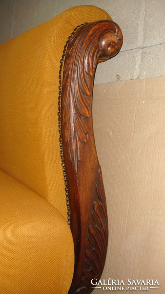 A couch with a personal linen holder.