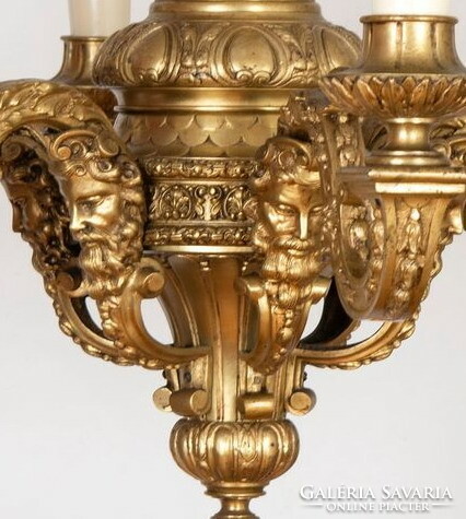 Gilded bronze chandelier decorated with plastic heads