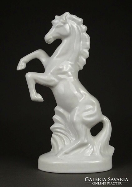 1M830 Ceramic horse with a branch standing on an old pedestal 23 cm