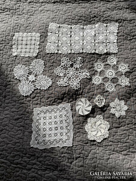 A pile of delicate little crocheted tablecloths together, handwork