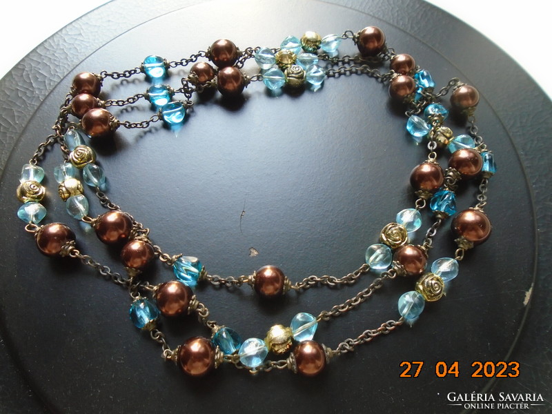 Long 2-row necklaces of antique gold, rose-shaped gold and turquoise beads strung on a bronze-colored chain