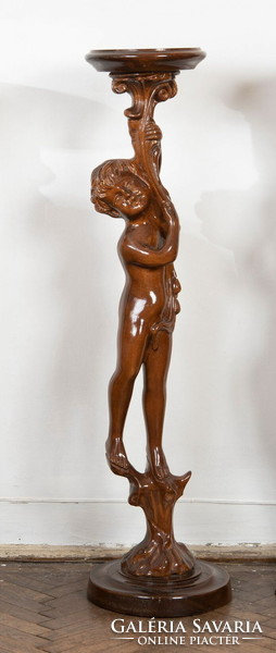 Carved wooden pedestal with a child figure