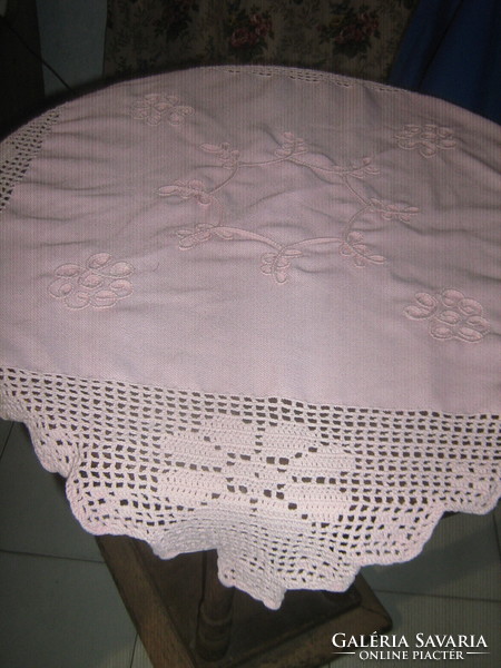 Cute hand-crocheted pink tablecloth with a sewn-on floral border