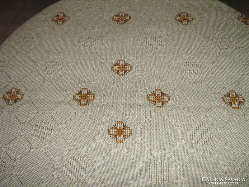 Beautiful, elegant, hand-embroidered ecru woven tablecloth with a lace edge